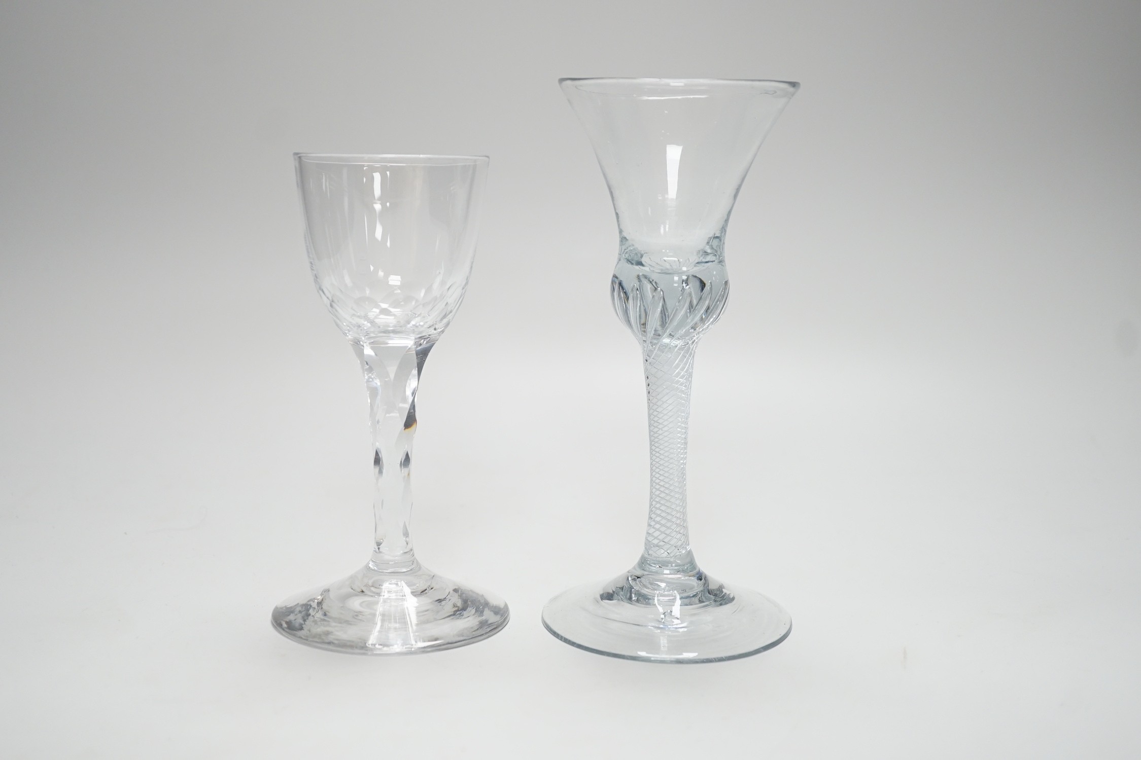 An 18th century air twist stem glass and a facet stemmed glass, tallest 18cms high